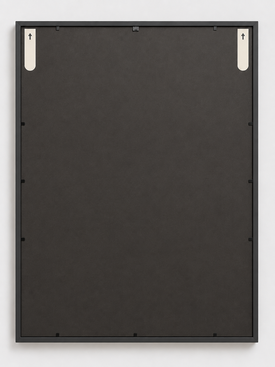 Back of a black frame showing two adhesive strips with arrows pointing up