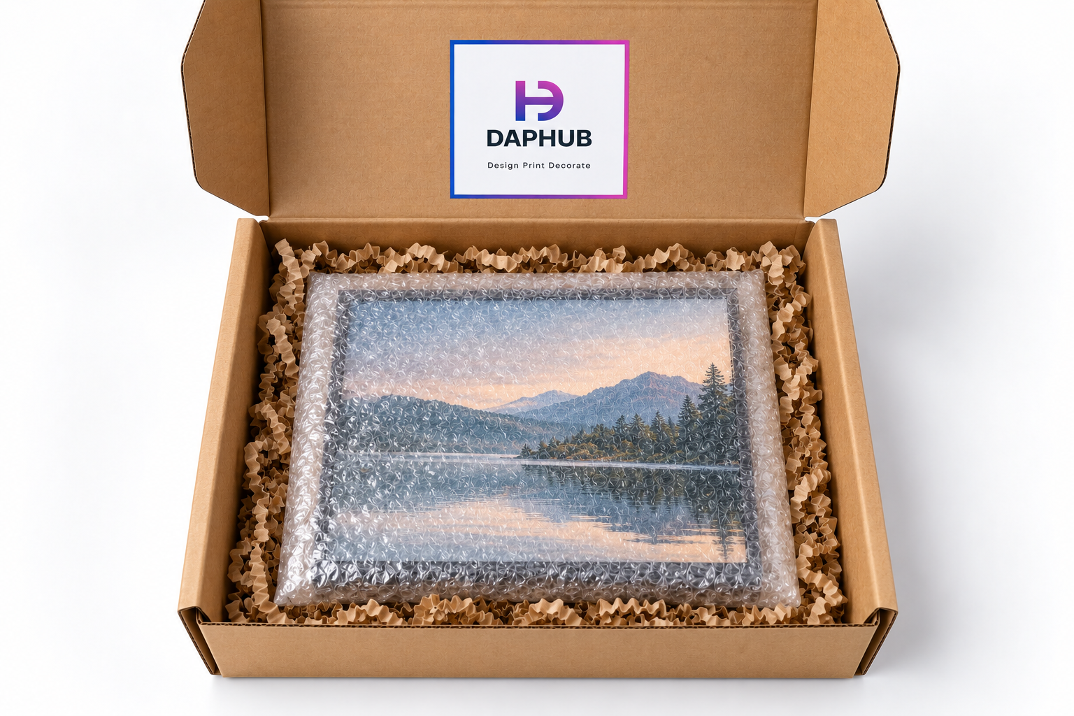 Wrapped framed print seated in a kraft box on crinkle paper